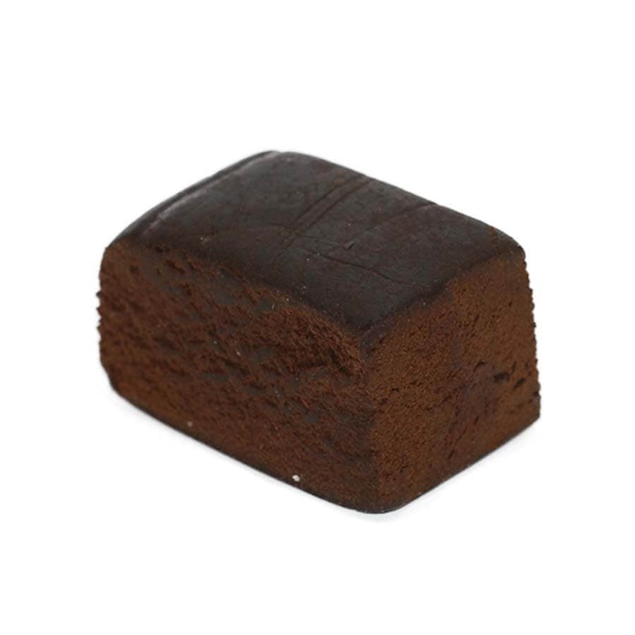 Red Lebanese hash block with warm reddish-brown tone, traditional pressed cannabis concentrate